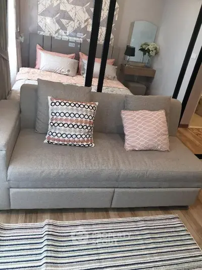 Stylish studio apartment with cozy living area and elegant bedroom decor.