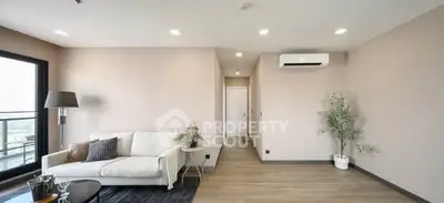 Spacious modern living room with elegant decor and balcony view