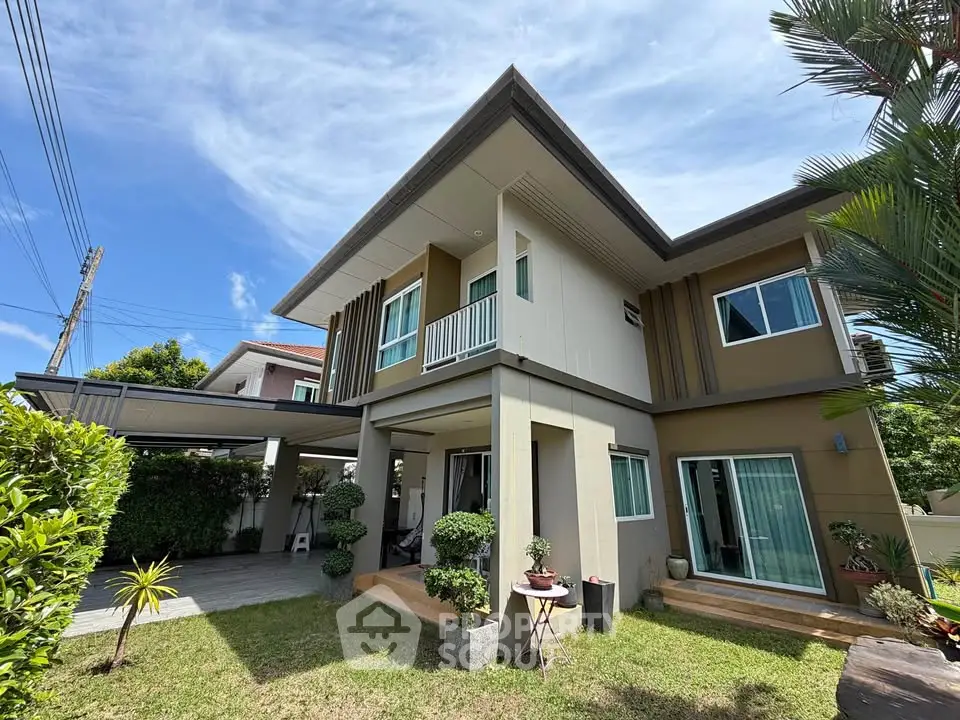 Modern two-story house with lush garden and spacious outdoor area, perfect for family living.