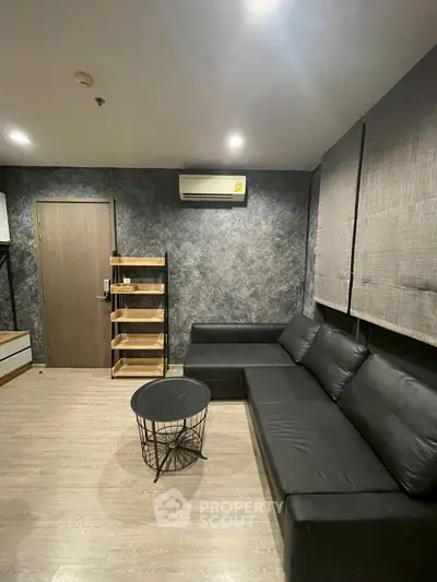 Modern living room with sleek black sofa and stylish decor