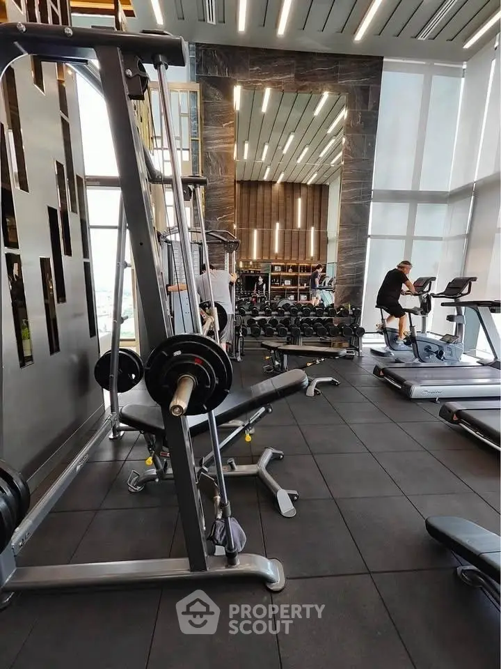 Luxurious high-rise gym with modern equipment and panoramic city views.