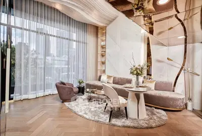 Luxurious modern living room with elegant decor and floor-to-ceiling windows.