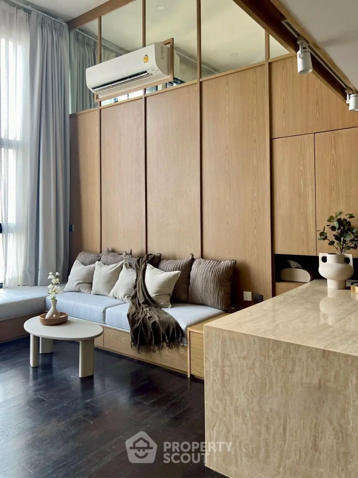 Modern living room with elegant wood paneling and cozy seating area