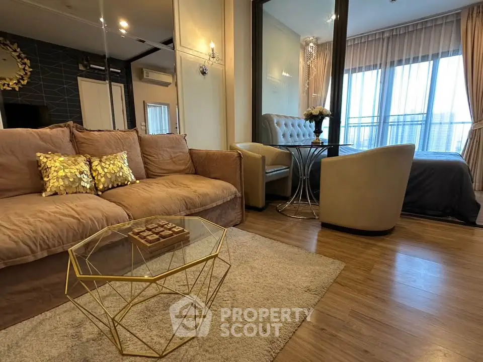 Luxurious living room with elegant decor and cozy seating area, featuring a stylish glass coffee table and plush cushions.