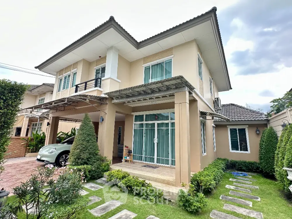 Charming two-story house with lush garden and carport in a serene neighborhood.