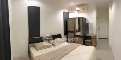 Spacious bedroom with modern furniture and air conditioning in a cozy apartment.