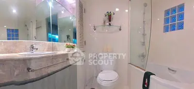 Modern bathroom with elegant fixtures and a sleek design, featuring a bathtub and stylish decor.
