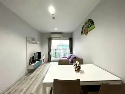 Modern living room with stylish decor and balcony view, perfect for urban living.