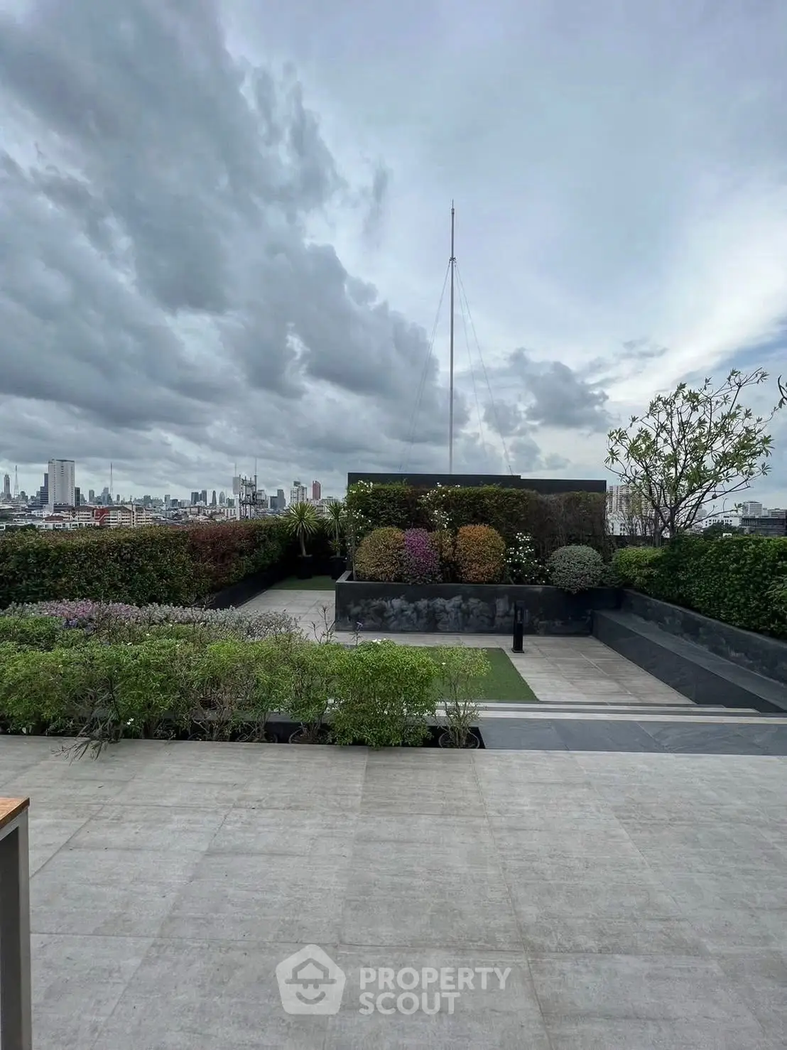 Stunning rooftop garden with panoramic city views and lush greenery.
