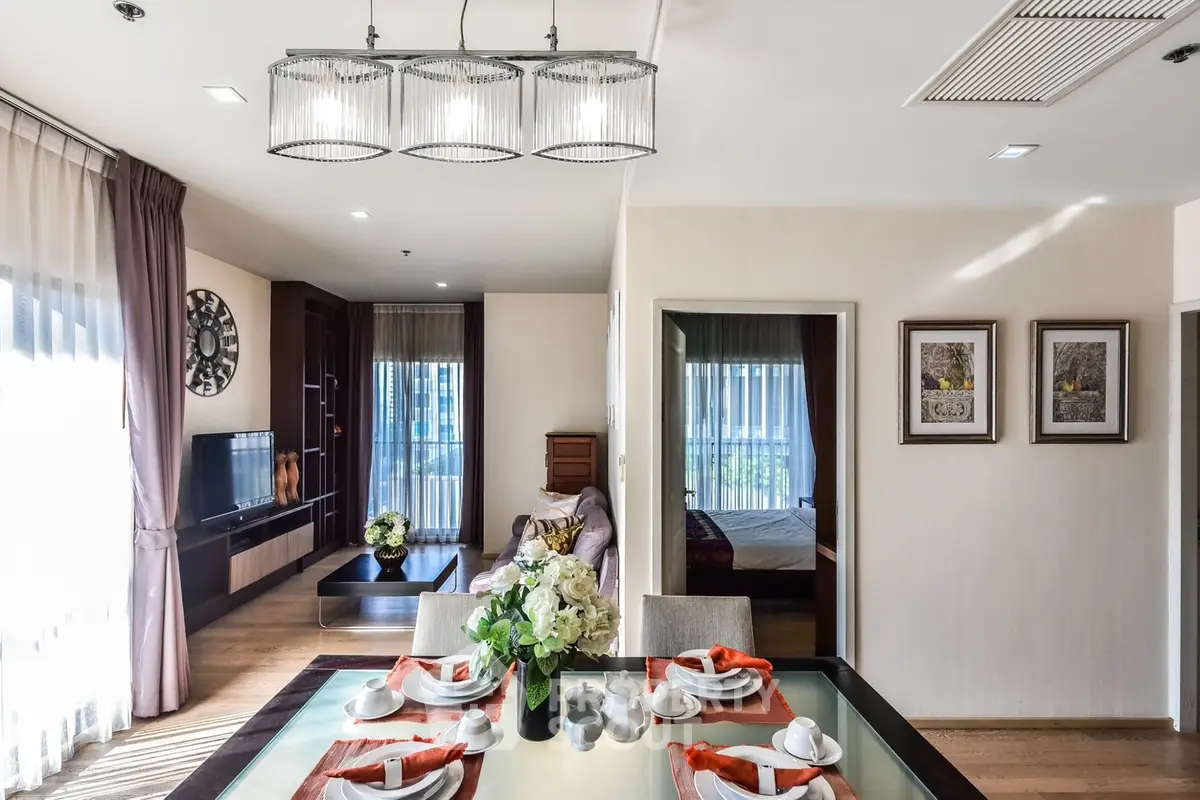 Elegant open-plan living and dining area with modern decor and natural light.