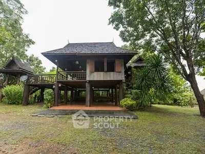 Charming traditional wooden house with elevated design and lush greenery