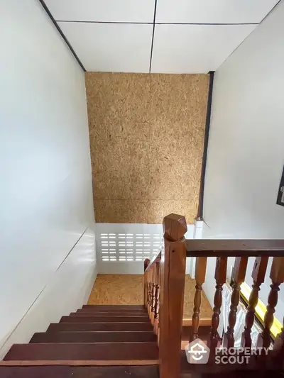 Staircase with wooden railing and modern design in a residential property