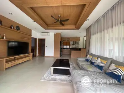 Spacious modern living room with elegant wooden ceiling and large TV unit