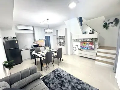 Modern open-plan living room and kitchen with stylish decor and staircase