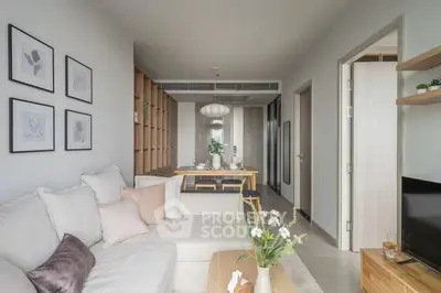 Modern living room with cozy sofa, stylish decor, and dining area in open layout apartment.