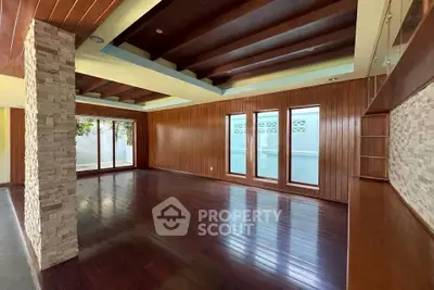 Spacious modern living room with wooden floors and large windows
