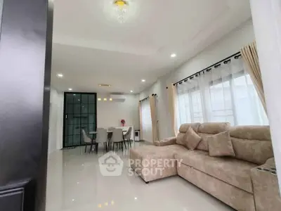 Spacious modern living room with elegant dining area and plush sofa, perfect for family gatherings.