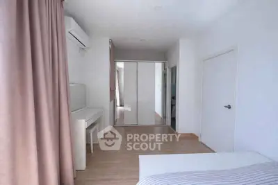 Spacious bedroom with modern decor and ample natural light