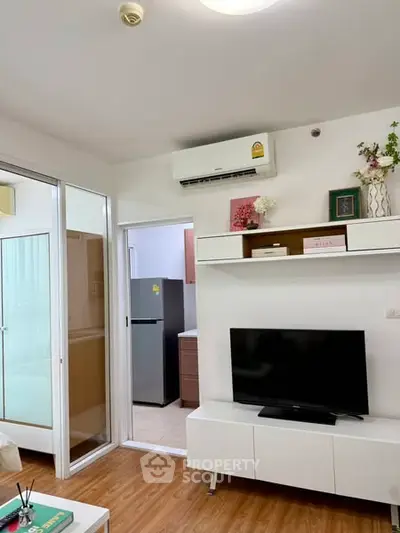 Modern living room with TV, air conditioning, and sleek storage units