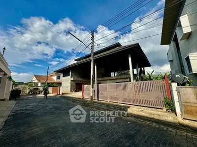 Spacious residential property with modern architecture and gated entrance in a serene neighborhood.