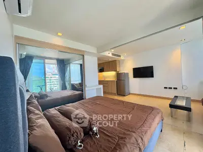 Spacious modern bedroom with open kitchen and stunning city view