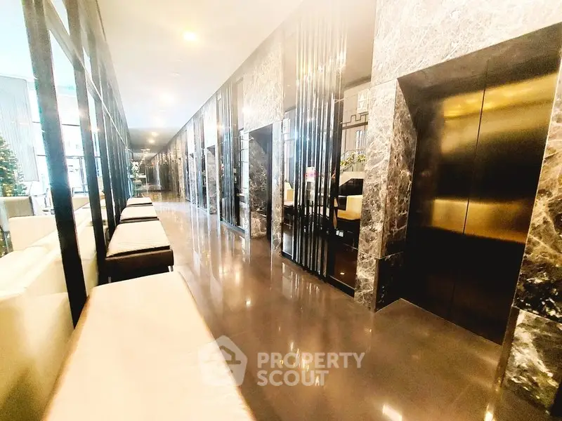 Luxurious modern building lobby with sleek marble finishes and elegant lighting.