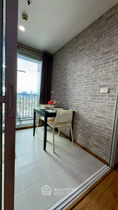 Charming small balcony with dining set and city view, perfect for cozy meals.