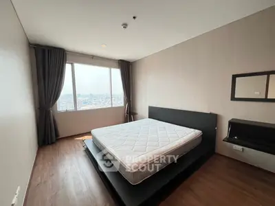 Spacious bedroom with city view and modern minimalist design