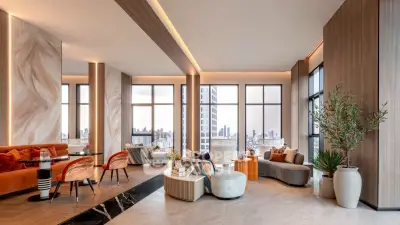 Luxurious modern living room with panoramic city views, elegant furniture, and stylish decor in a high-rise apartment.
