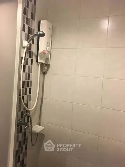 Modern bathroom shower with sleek tile design and water heater