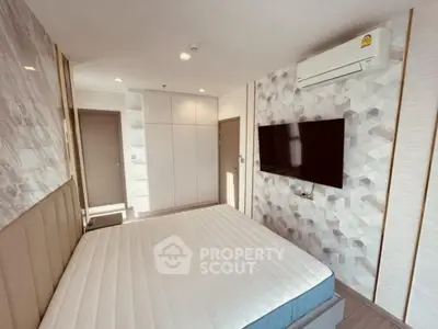 Modern bedroom with stylish decor and wall-mounted TV