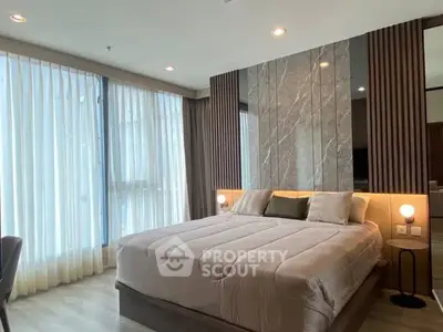 Luxurious modern bedroom with elegant decor and large windows for natural light.