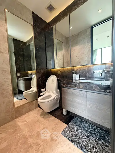 Luxurious modern bathroom with elegant marble finishes and sleek fixtures.