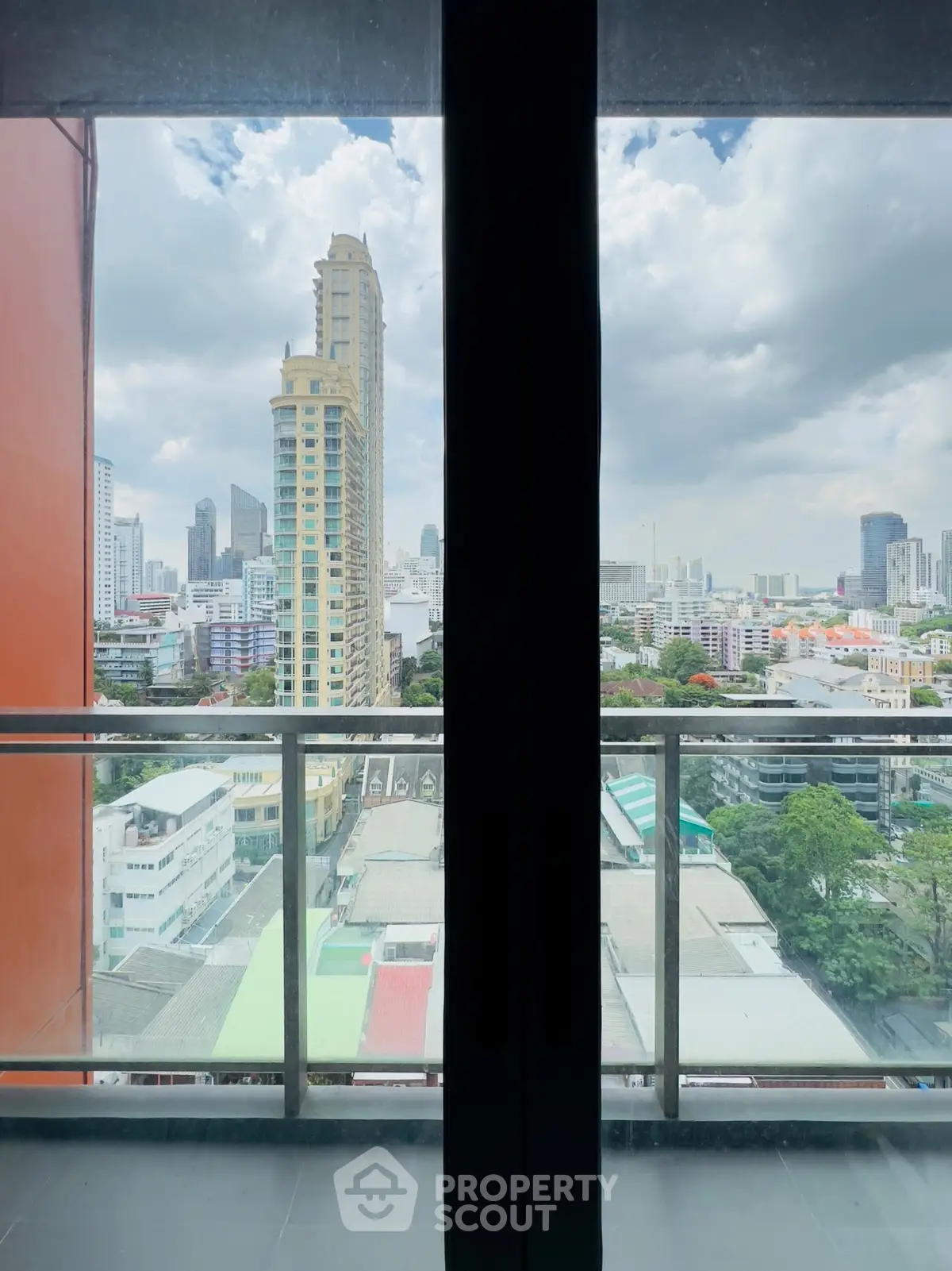 Stunning cityscape view from a high-rise balcony with modern urban skyline.