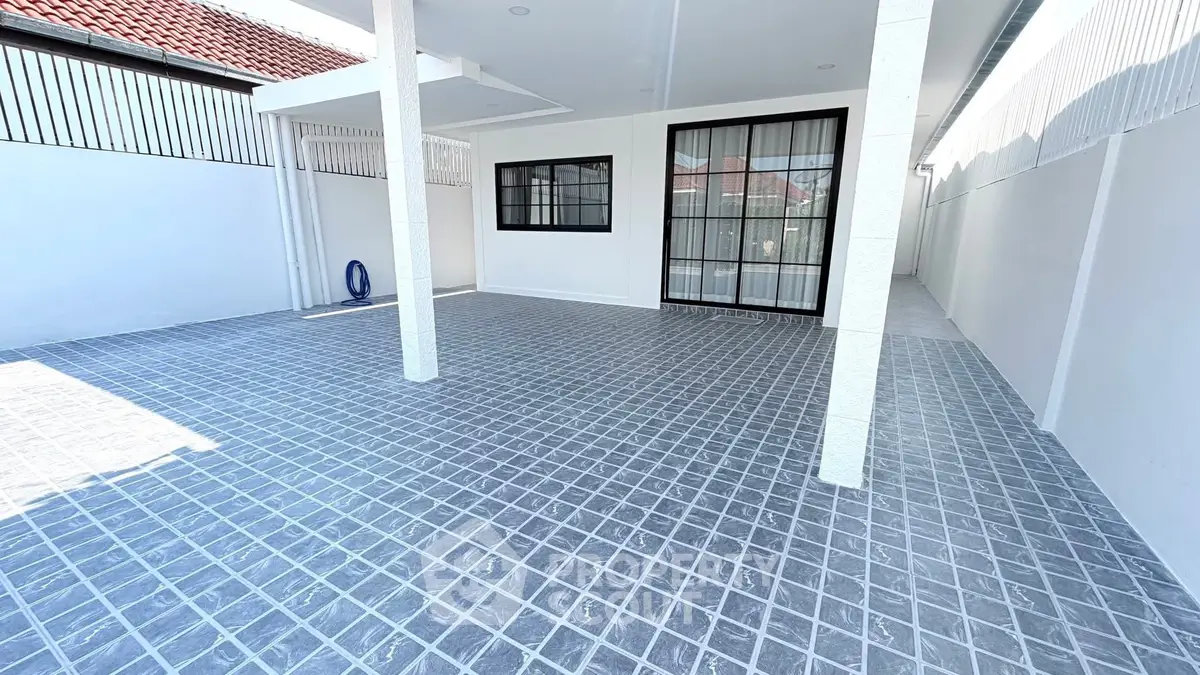 Spacious covered outdoor area with tiled flooring and modern design