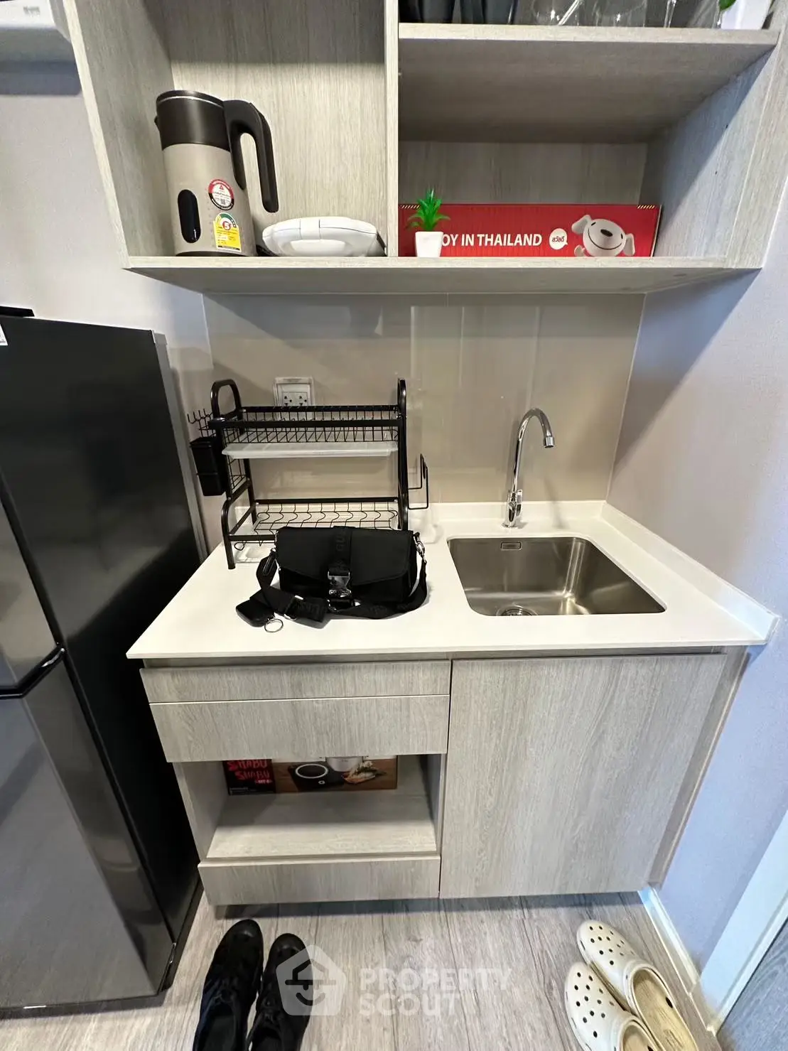 Compact modern kitchen with sleek cabinetry and stainless steel sink