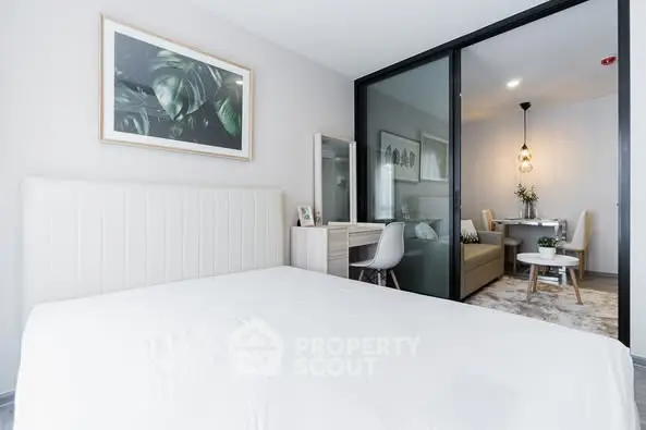 Modern bedroom with sliding glass doors leading to a stylish dining area.
