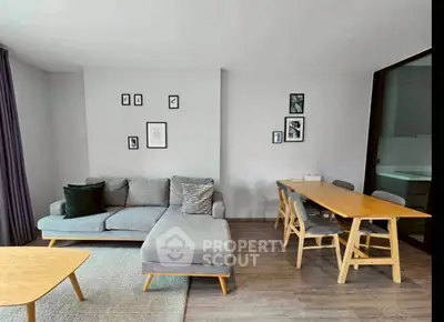 Modern living room with stylish furniture and dining area, perfect for urban living.