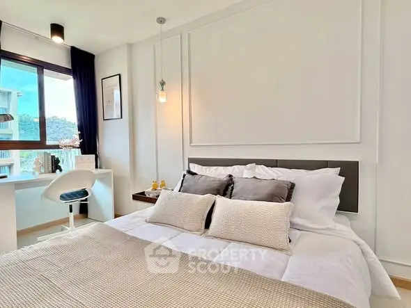 Modern bedroom with stylish decor and scenic window view