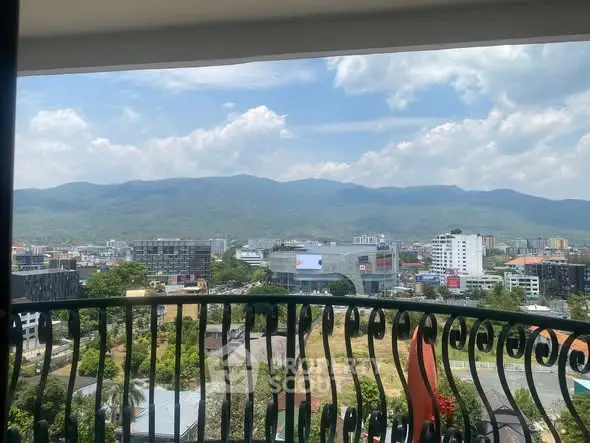 Stunning balcony view overlooking cityscape and mountains, perfect for urban living with a touch of nature.