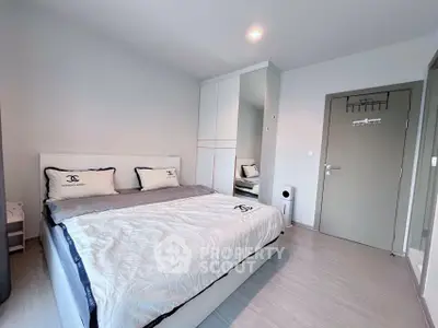 Modern bedroom with sleek design, featuring a comfortable bed and stylish wardrobe in a bright, airy space.