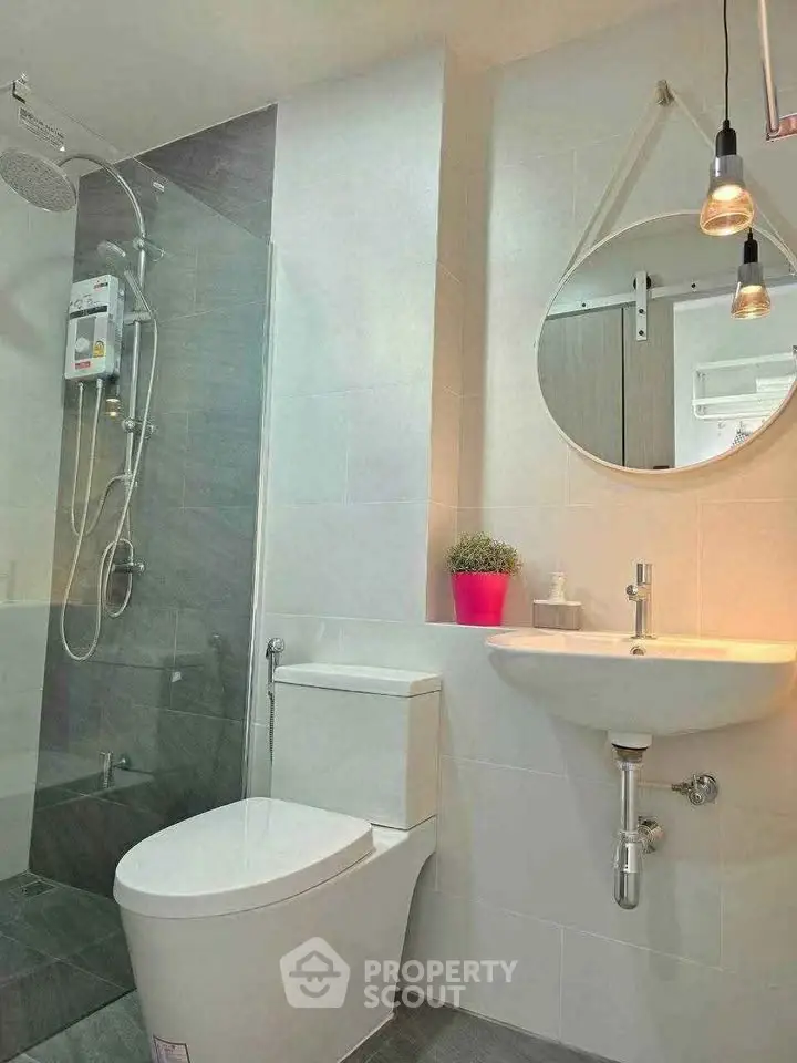 Modern bathroom with sleek fixtures and stylish lighting in a contemporary home.