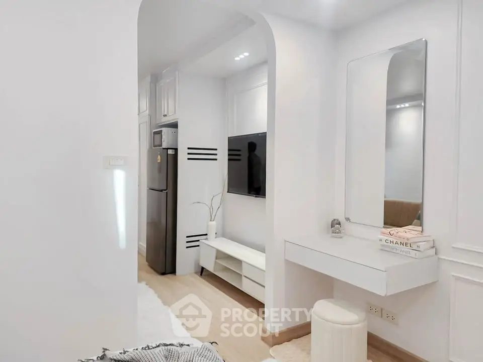 Modern minimalist living space with sleek decor and built-in TV unit.