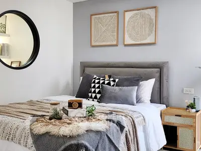 Stylish modern bedroom with cozy decor and geometric wall art