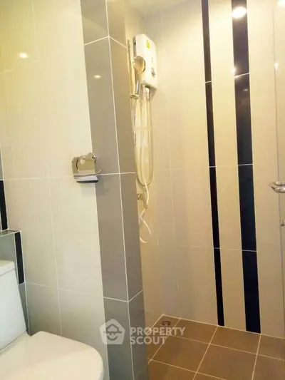 Modern bathroom with sleek tile design and built-in shower heater
