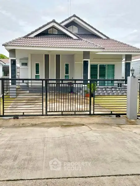 Charming single-story house with modern design and gated entrance, perfect for family living.