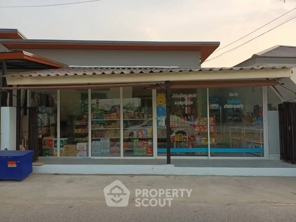 Charming small retail shop with glass facade and stocked shelves, ideal for local business opportunities.