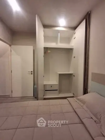 Cozy bedroom with built-in wardrobe and soft lighting