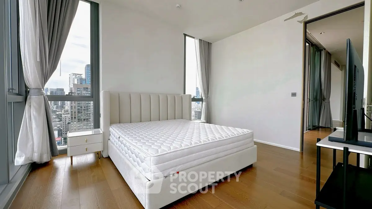 Spacious modern bedroom with city view and elegant decor