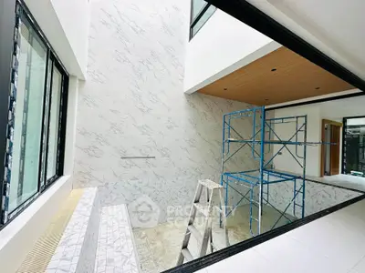 Modern interior under construction with marble walls and large windows